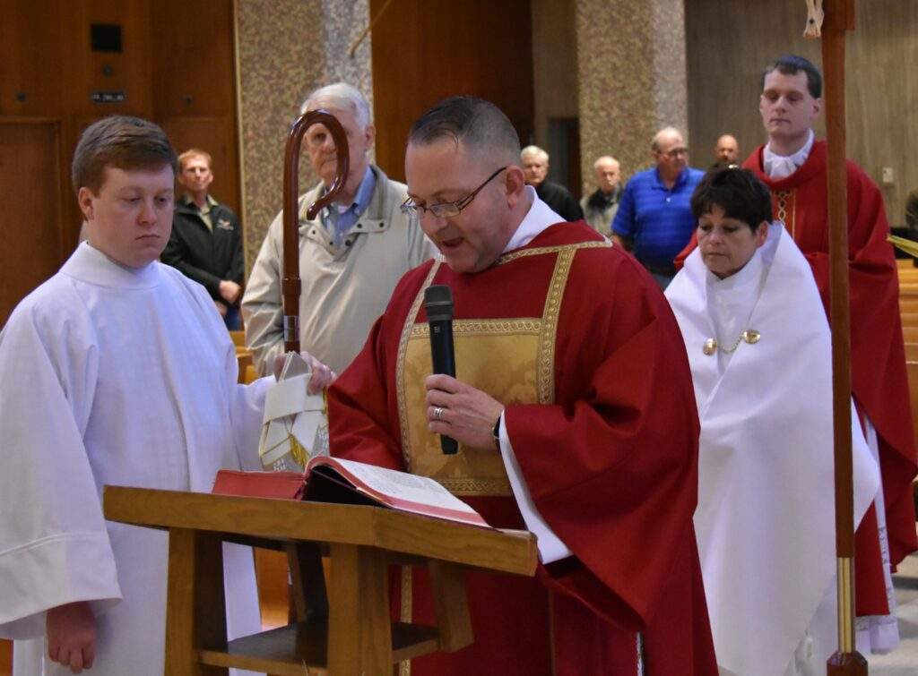 Deacon speaks during the blessing of the palms