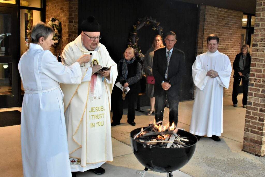 Father Misbrener begins Mass in front of a fire at the Easter Vigil in Columbiana