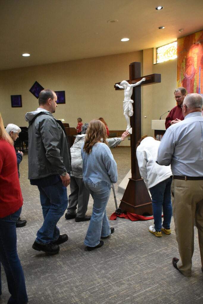 Parishioners venerate the cross at St. William Parish on Good Friday