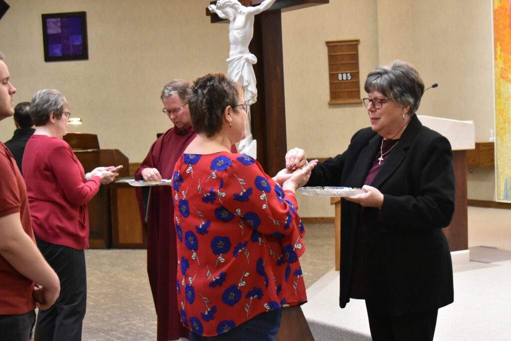 Parishioners receive communion at St. William Parish on Good Friday