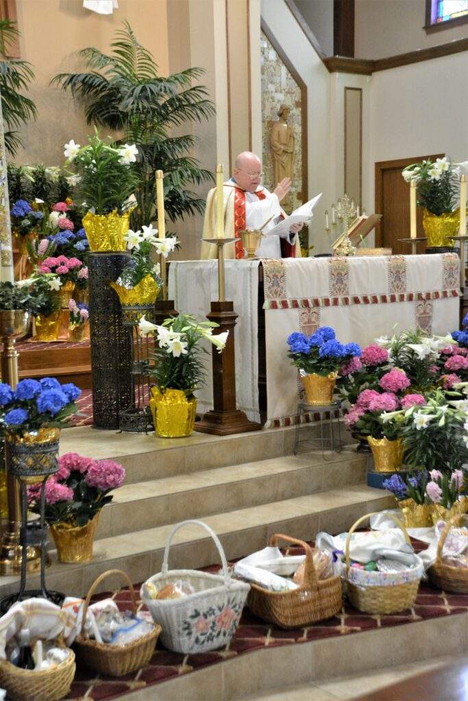 Fr. Kelly blesses more than 20 Easter Baskets around the altar at St. Rose.