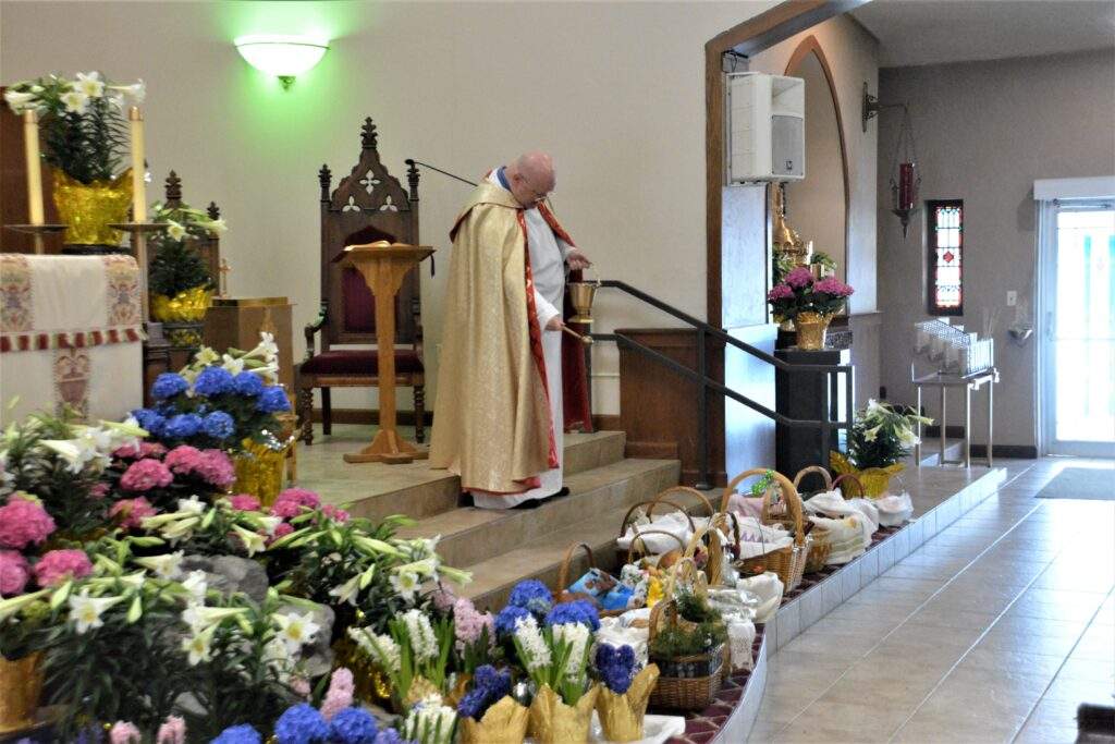 Fr. Kelly blesses more than 20 Easter Baskets around the altar at St. Rose.