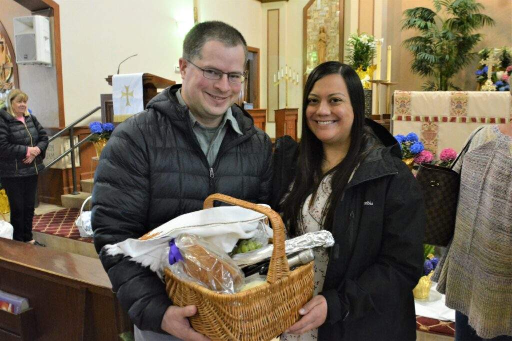 A couple poses with their Easter Basket at St. Rose.