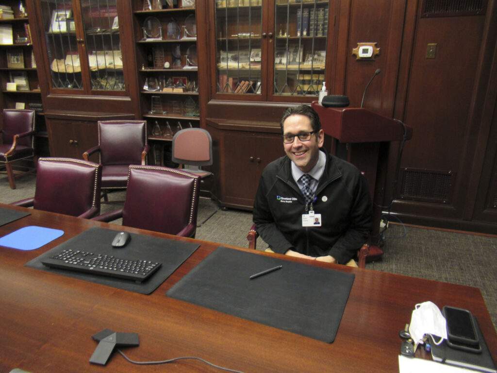 P.J. sits at a table.