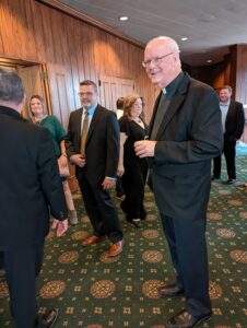 Priest mingling with the crowd.