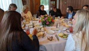 Photo of attendees, having conversations over dinner.