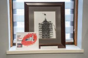 Photograph of St. Columba Cathedral bell tower covered in scaffolding with poster promoting rebuilt church