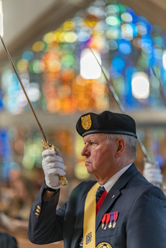 Member of the Knights of Columbus raises his sword at St. Mary Parish in Orwell. Photo by Brian Keith