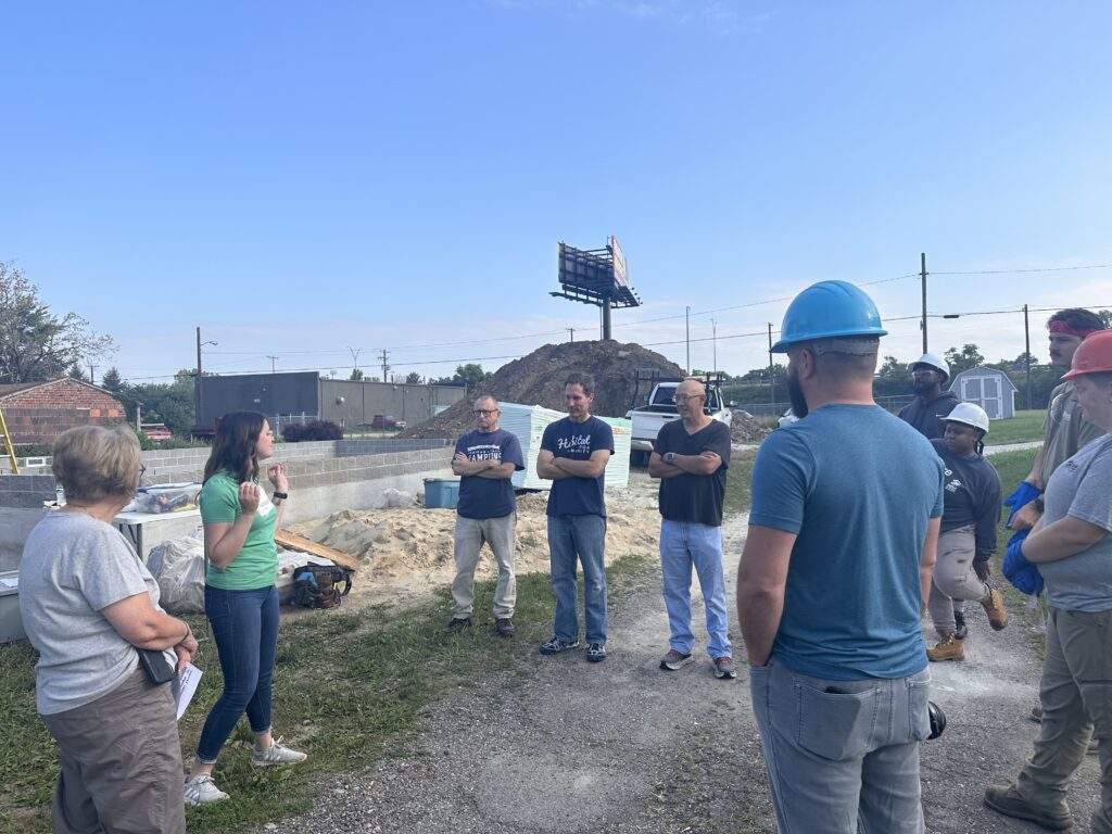 Volunteers from St. Michael the Archangel stand around the build site.