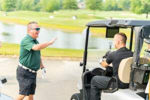 Bishop Bonnar waves to a participant as they enter the course.