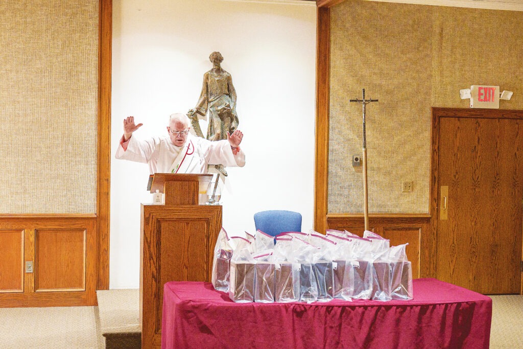 Deacon Ron Layko from St. Christine Parish performs the All Souls Remembrance Service for unclaimed cremated remains. Photo by Jimmy Joe Savage.