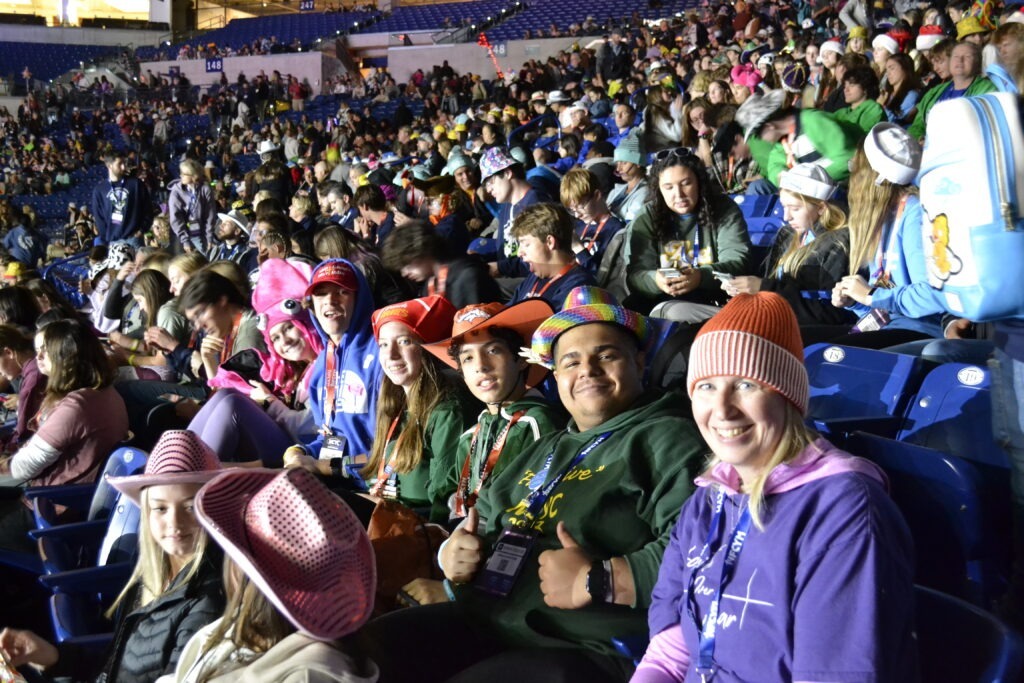 The group from Youngstown smiles at the camera while watching a presentation