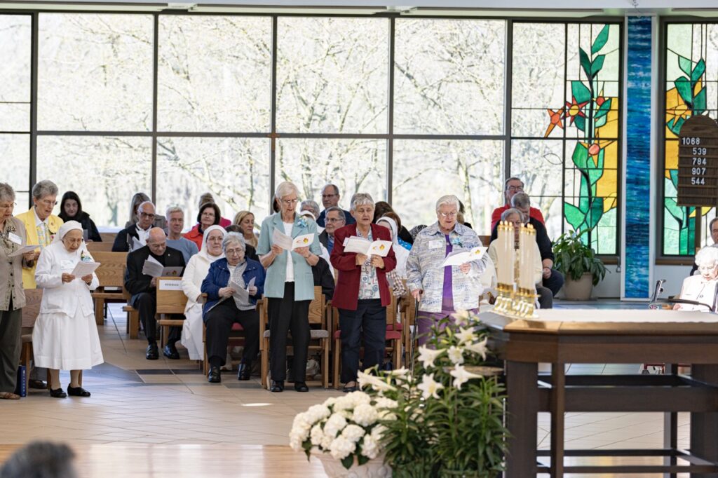 Religious sisters stand and sing during Mass. Photo by Brian Keith.