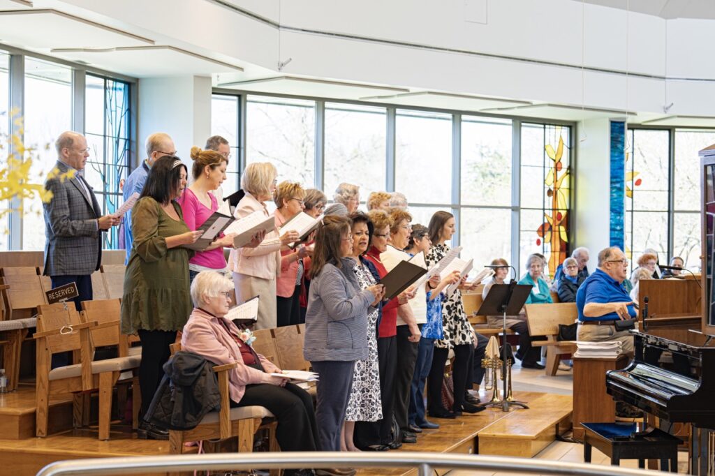 The choir stands behind the organ, singing for the Mass. Photo by Brian Keith.