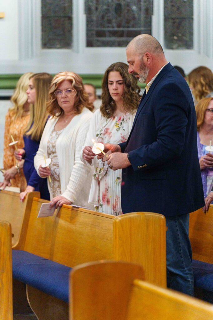 Parishioners light their candles at the Easter Vigil 2024 at Holy Trinity Parish in East Liverepool. Photo by Jimmy Joe Savage.