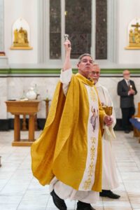 Priest blesses the parishioners with Holy water at the Easter Vigil 2024 at Holy Trinity Parish in East Liverepool. Photo by Jimmy Joe Savage.