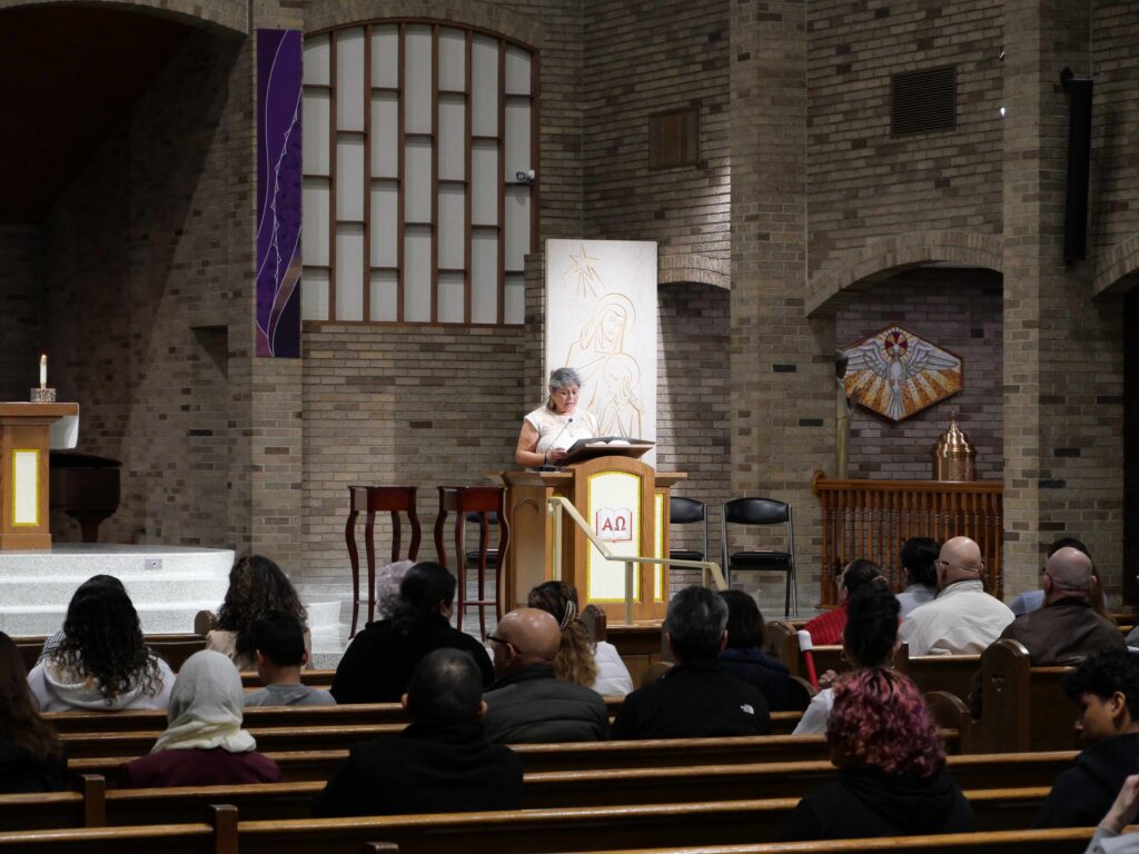 Lector speaks at the ambo during the Hispanic Ministry Summit