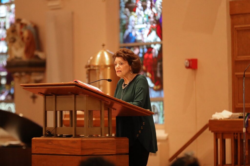 A female lector stands at the ambo at St. Paul Parish in North Canton on Good Friday 2024. Photo by Ed Hall, Jr.