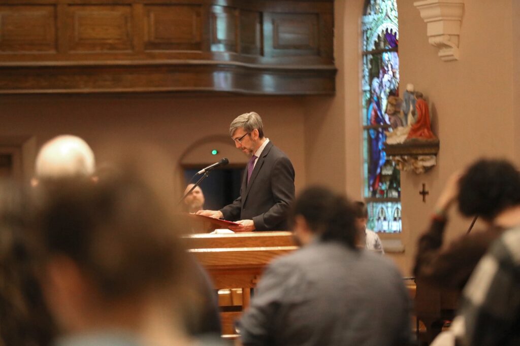 Male lector stands at the ambo at St. Paul Parish in North Canton on Good Friday 2024. Photo by Ed Hall, Jr.