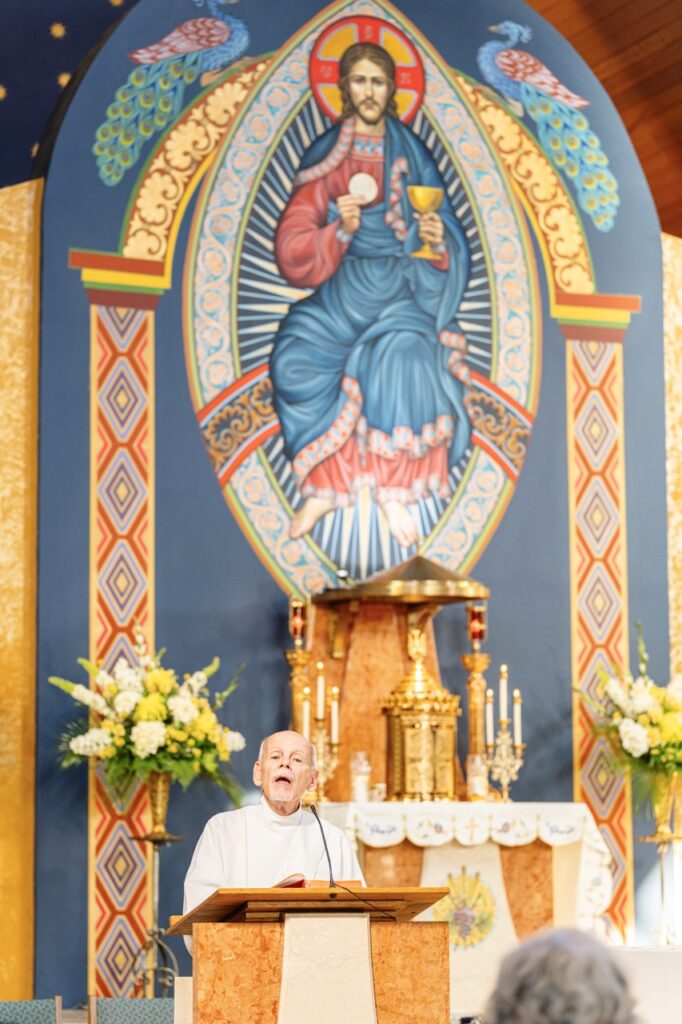 A man in white does the readings for the Assumption Pilgrimage in North Jackson. Photo by Brian Keith.