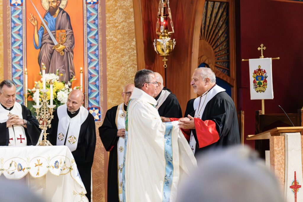 Bishop Bonnar greets Eastern Rite bishop for the Assumption Pilgrimage in North Jackson. Photo by Brian Keith.