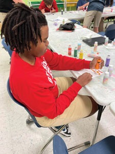 A student participates in fine art class