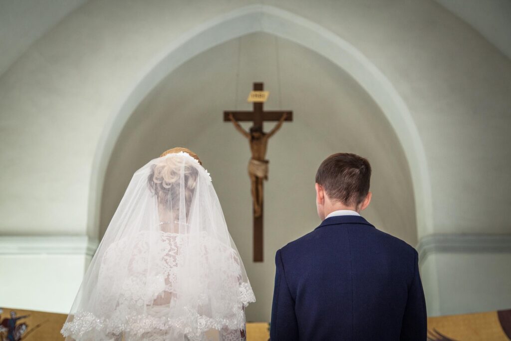 image of bride and groom standing at an altar. 