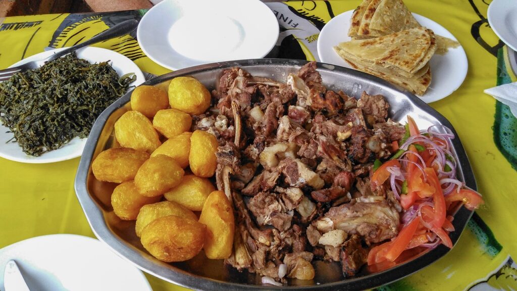 Nyama choma, Swahili for roast meat, is slow cooked in outdoor kitchen and eaten with the hands. This order was 1 kilo of the most popular, mbuzi choma or roasted goat.