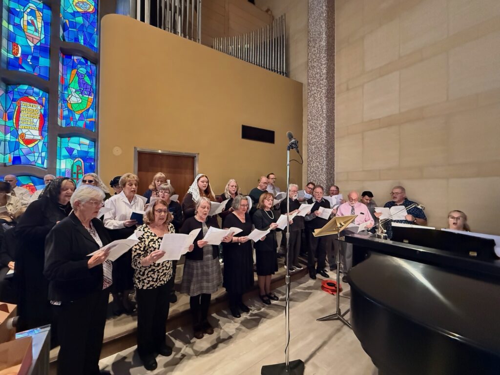 choir sings during the gold mass