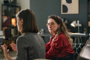 Two women sit down and discuss their faith.